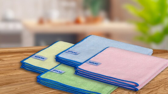 Red, blue, green and yellow folded cloths on wooden surface