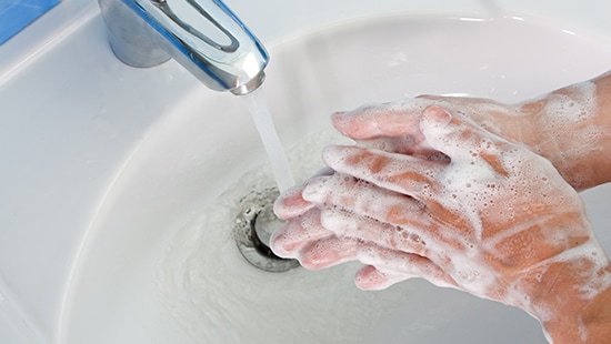 Hands washing in a sink