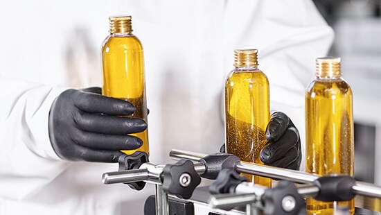 Three bottles of liquid in a personal care and cosmetics facility