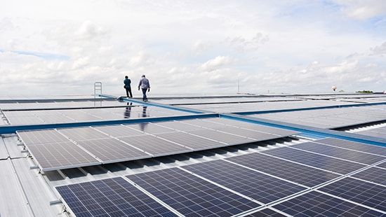 Ecolab technicians on a roof with solar panels